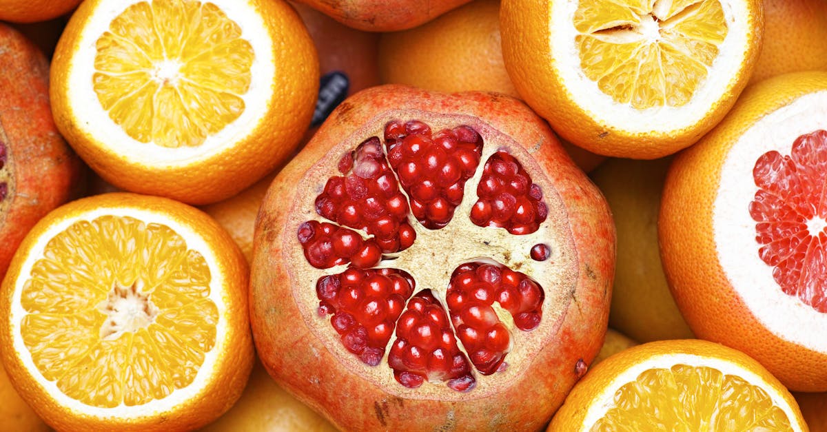 Colorful mix of sliced citrus fruits and pomegranates showcasing freshness.