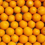 A top view of vibrant oranges neatly arranged, showcasing freshness and juiciness.
